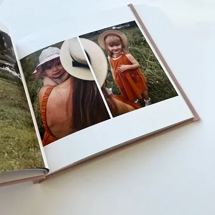 Разворот семейной фотокниги с фото мамы и ребенка в шляпе на природе